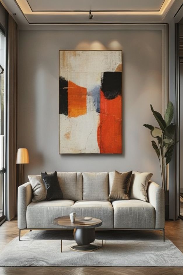 A wide shot of a contemporary living room Above a mid-century modern sofa a large piece of abstract art is hung signific