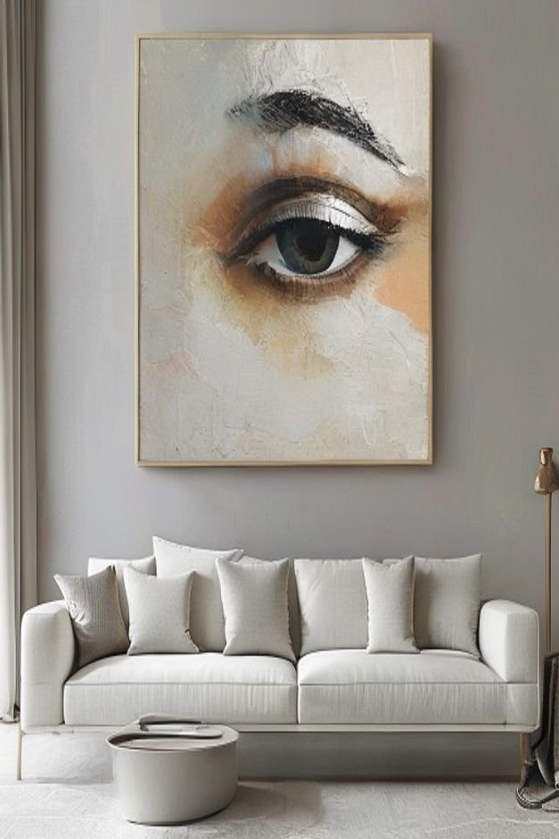 A close-up eye-level shot of a large commanding piece of abstract art centered above a minimalist light grey sofa The ar