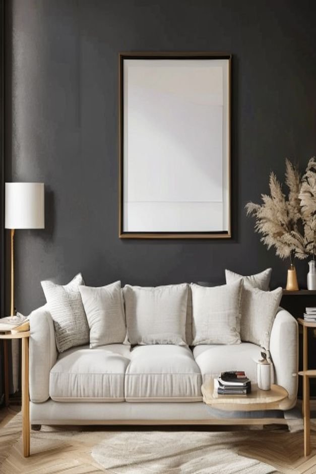 A clean contemporary living room A light-colored sofa against a dark accent wall Above the sofa a large framed print cle